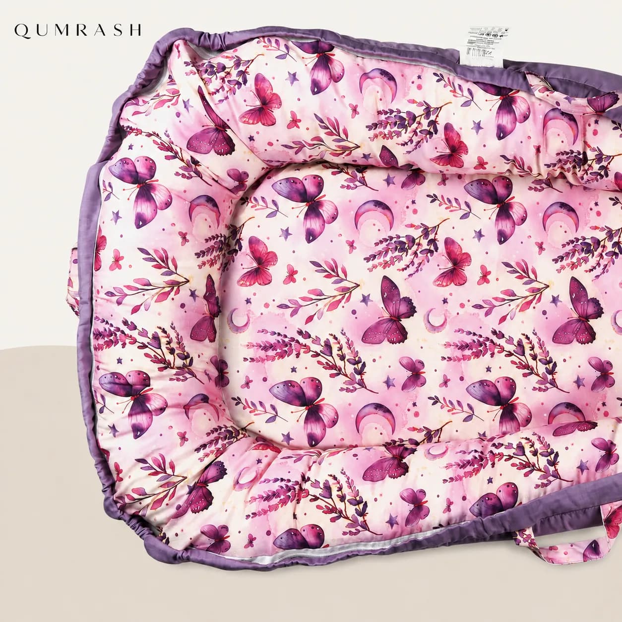 Close view of the butterfly and lavender print fabric and padded bumper stitching